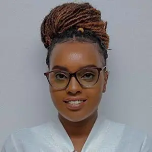 Laura Tich wearing a white blouse against a light gray background